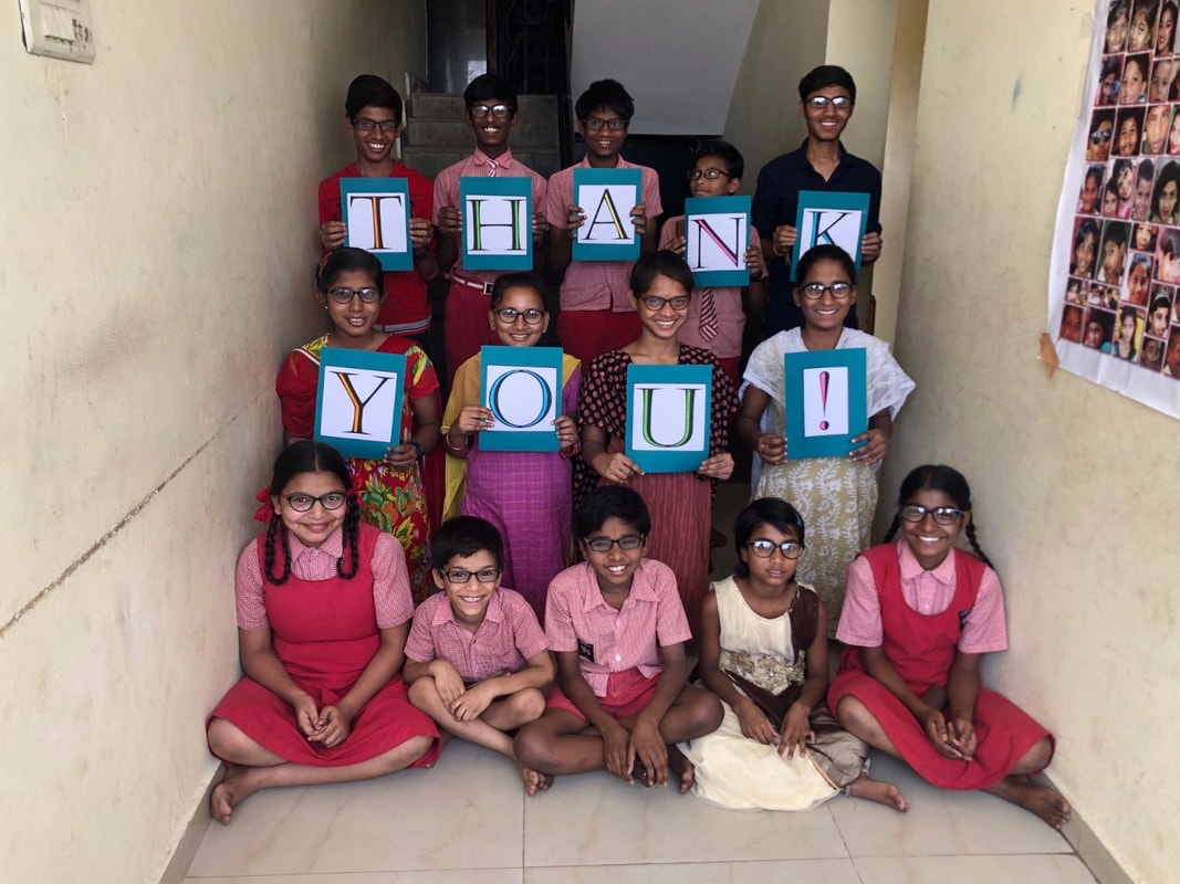Children holding thank you signs